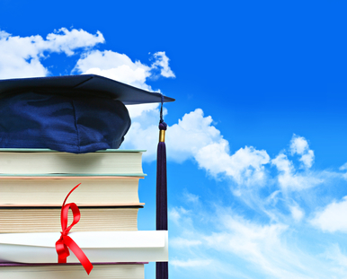 Stack of books with diploma against blue sky